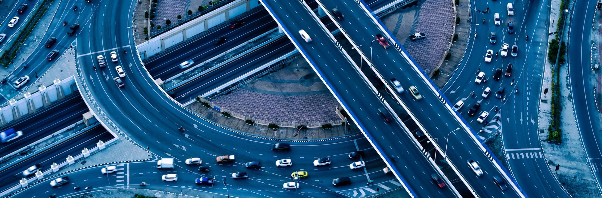 Aerial view of a multi-level highway interchange busy with traffic